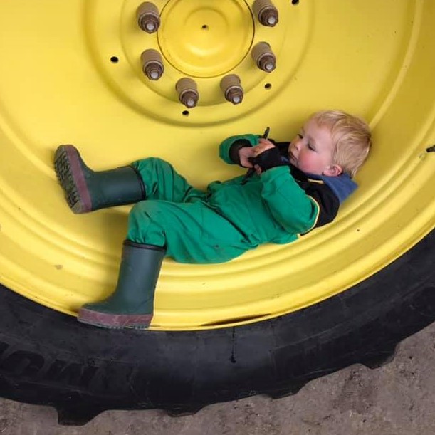 kid in tractor wheel